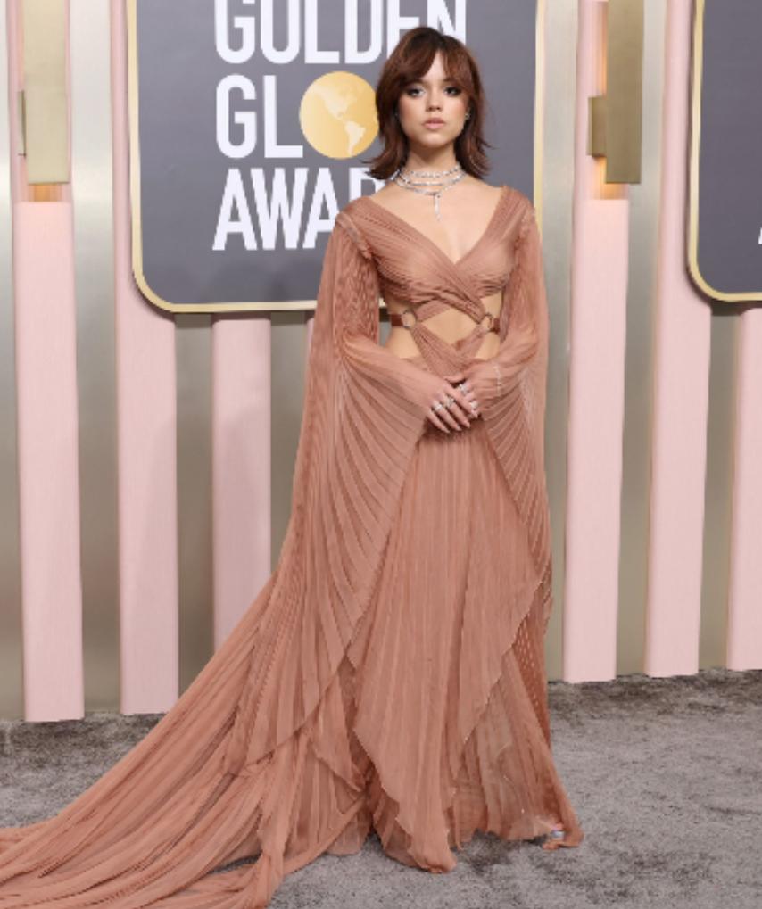 Jenna Ortega: The young actor who is currently winning hearts as Wednesday Addams on her popular Netflix show, 'Wednesday', stole the show with her stunning pinkish-brown Gucci gown. The pleated-draping and dramatic elongated sleeves alleviated the glam effect of the overall ensemble.